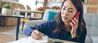 Woman on phone taking notes