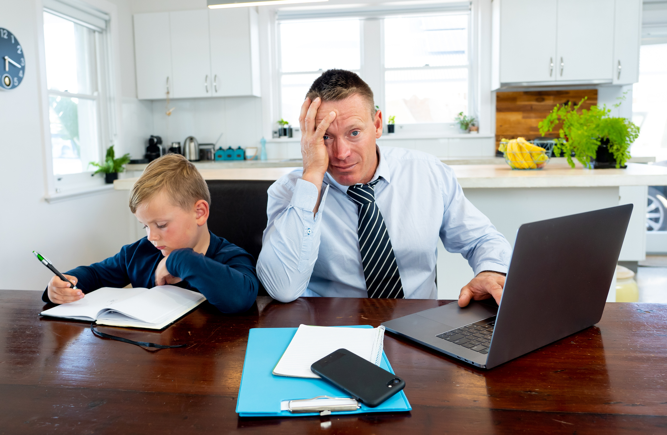 Stressed parent dealing with work from home and home schooling